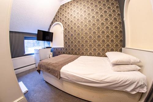a hotel room with a bed and a window at Quayside Hotel & Bar in Boston