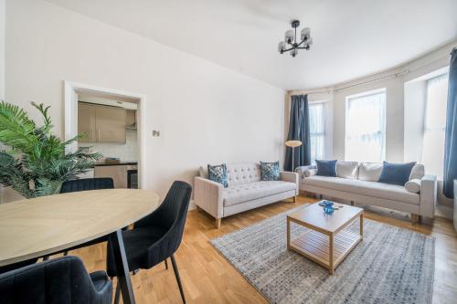 a living room with a table and a couch at Number 5 in Margate