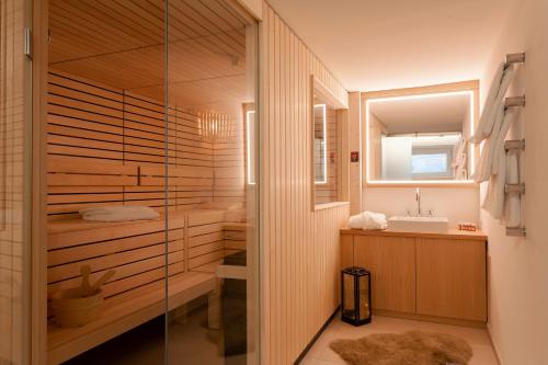 a bathroom with a shower and a sink at Thurnhers Residences Serviced Apartments in Lech am Arlberg
