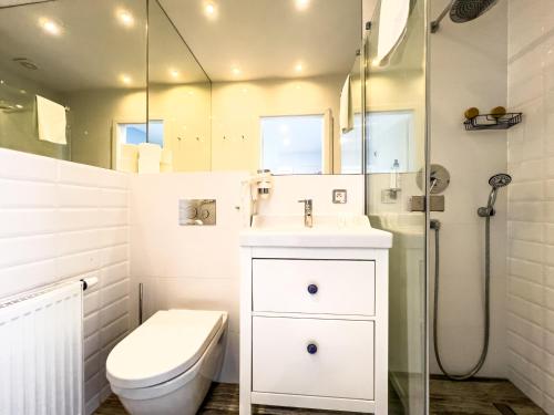 a bathroom with a toilet and a sink and a shower at Willa Błękit Hotel by Dorota Szelągowska in Mielno