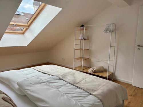 a bedroom with a large bed in a attic at GIPFELGLÜCK - Ferienwohnung zentral in Nesselwang in Nesselwang