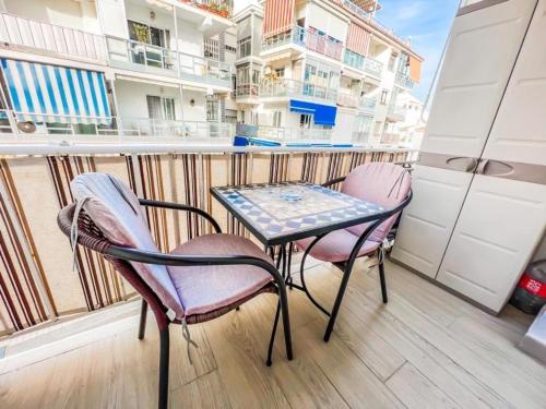 a small table and two chairs on a balcony at Reformed studio apartment in central Nerja 3K in Nerja