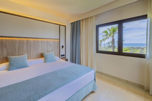 a bedroom with a large bed with a view of the ocean at Impressive Playa Granada Golf in Motril