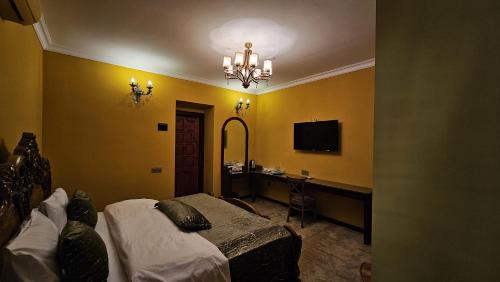 a bedroom with a bed and a desk and a television at Grandview Boutique Hotel in Baku