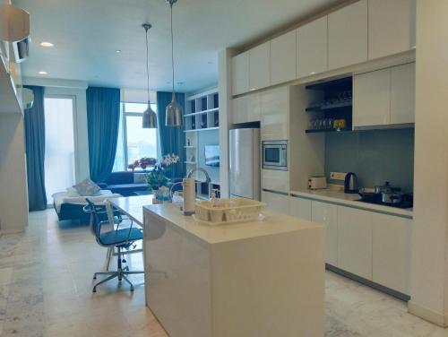 a large kitchen with a counter and a couch at KLCC Suites At Platinum By MiM in Kuala Lumpur