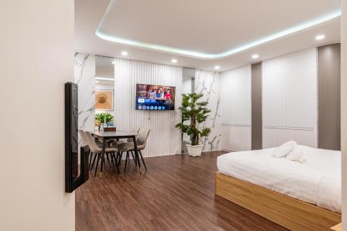 a bedroom with a bed and a dining room at A Boi Apartment at District 3 in Ho Chi Minh City