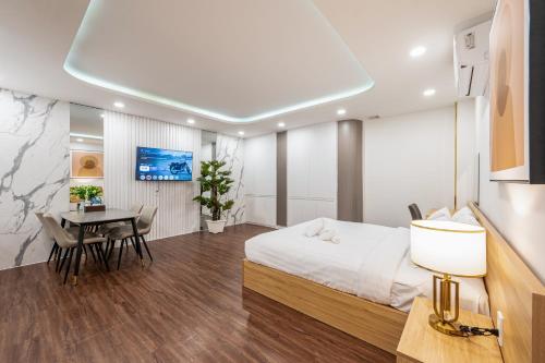 a bedroom with a bed and a desk and a table at A Boi Apartment at District 3 in Ho Chi Minh City