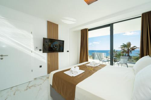 a bedroom with a bed with a view of the ocean at Villa London in Novalja