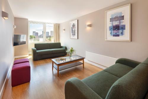 a living room with a couch and a table at Marlin Apartments London Bridge - Empire Square in London