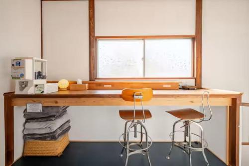 a wooden desk with a chair and a window at Guesthouse giwa - Vacation STAY 14229v in Mishima