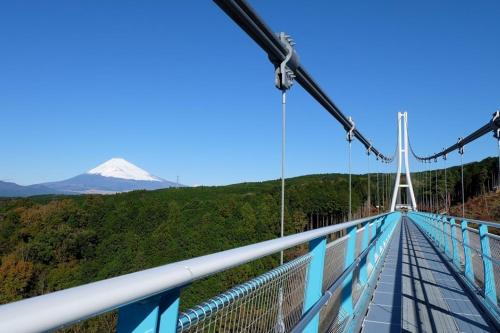 a suspension bridge with a mountain in the background at Guesthouse giwa - Vacation STAY 23190v in Mishima