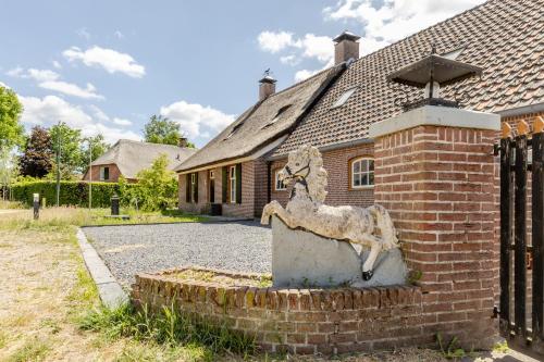 a statue of a goat in front of a house at Duin & Daal in Helvoirt