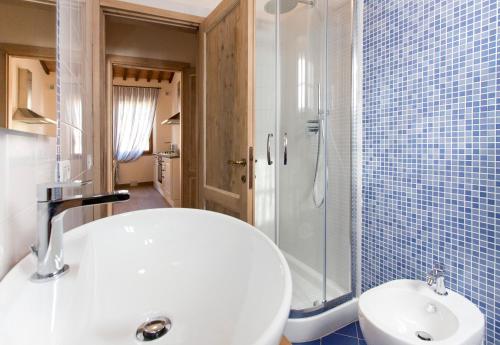 a bathroom with a white sink and a shower at Casale San Galgano in Chiusdino