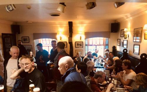 a group of people sitting in a bar at The Clachan Inn in Drymen