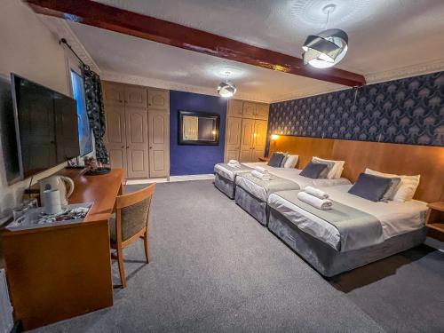 a hotel room with two beds and a desk at Quayside Hotel & Bar in Boston