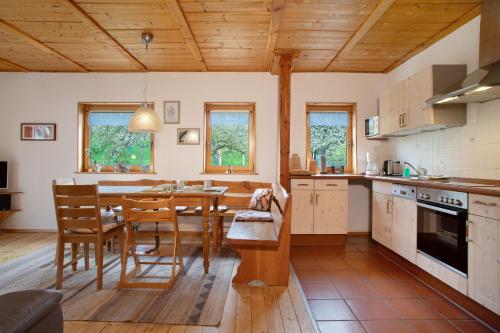 a kitchen with a table and a dining room at Ferienhaus am Ried in Burgweiler