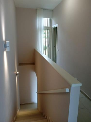 a staircase in a room with a mirror at Whisky Green Coast Hotel & Apartments in Palasë