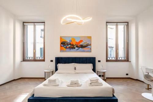 a bedroom with a large bed in a room with windows at Italian Essence - Bergamo Center in Bergamo