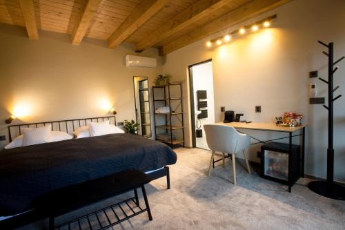 a bedroom with a bed and a desk with a chair at Apart Hotel Jablonec in Jablonec nad Nisou