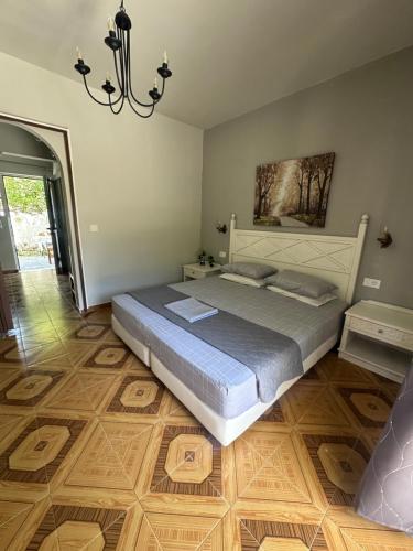 a bedroom with a bed and a chandelier at Dionysia Studios in Kefalos
