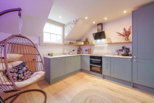 a kitchen with a swing in a room at Tellers secret loft apartment The Bank of England in Bristol