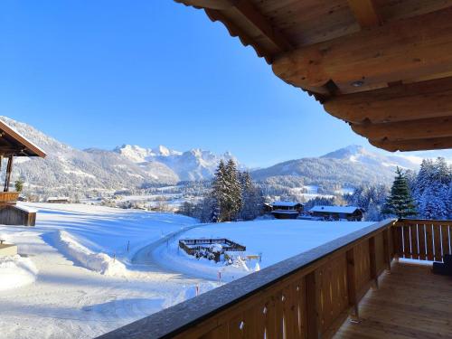 a winter view from the balcony of a cabin at Ferienwohnung Lacken in Fieberbrunn
