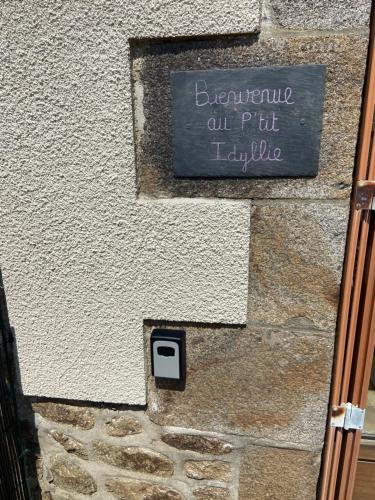 a sign on the side of a stone building at Maison calme in Bazouges-sous-Hédé