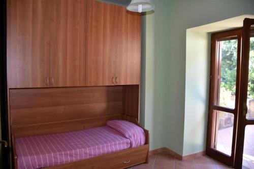 a bed in a room with a purple mattress at Bellezza In Cilento Panoramic Apts in Castellabate