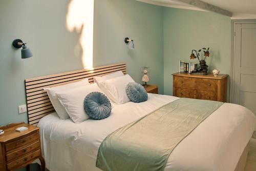 - une chambre avec un grand lit et 2 oreillers bleus dans l'établissement Le Château de La Seigne, à Villemoustaussou