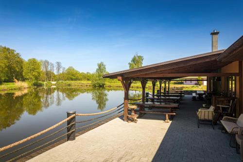 a dock with tables and chairs next to a lake at Marine Závlahy in Hrdějovice