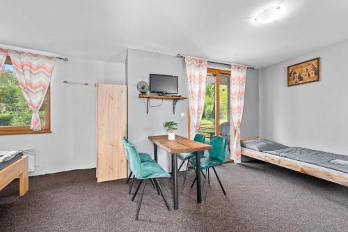 a room with a table and chairs and a bed at Marine Závlahy in Hrdějovice