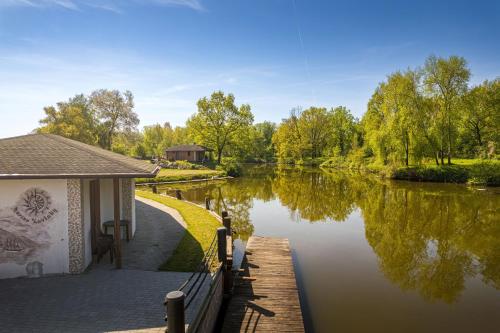 a house with a dock next to a river at Marine Závlahy in Hrdějovice