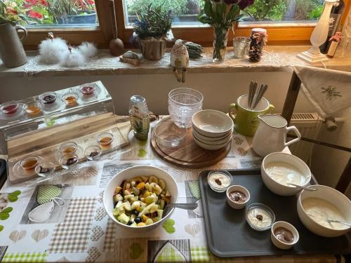 a kitchen with a table with a bowl of food at Pension Marianne - Chiemgau Karte in Inzell