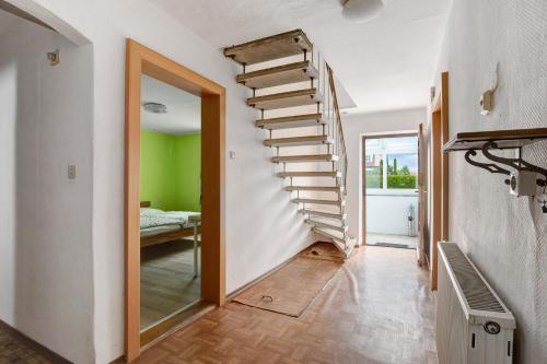 a spiral staircase in a room with a bedroom at Haus Steinheim in Dillingen an der Donau