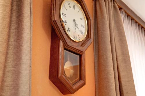 a clock hanging on a wall next to a window at Haus Steinheim in Dillingen an der Donau