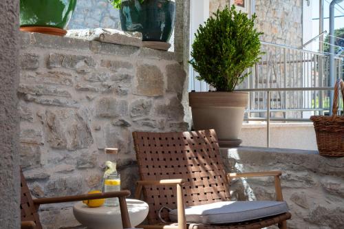 a room with two chairs and a window at Stone house Casa Lumina in Božava
