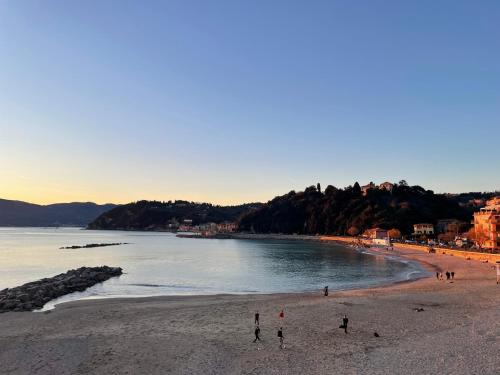 a group of people standing on a beach at La Gritta in Lerici