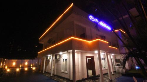 a white building with lights on it at night at The Beach Villa in Mount Lavinia