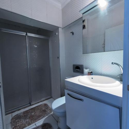 a bathroom with a shower and a sink and a toilet at Hbs Hotel in Kuşadası
