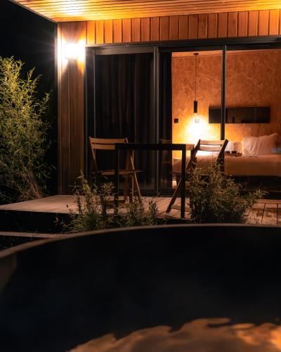 a view of a room with a bed and a table at Le Piloti in Saint-Quentin-en-Tourmont