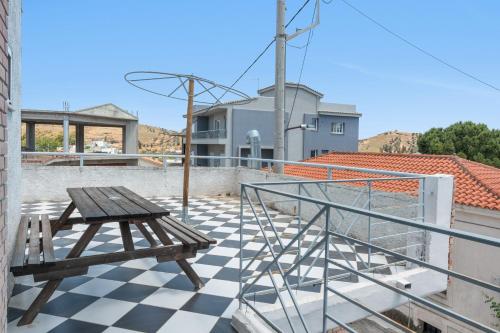 a wooden bench sitting on top of a roof at Motel katerina in Keratea