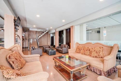 a living room with two couches and a coffee table at Townhouse Oak Padang near RTH Imam Bonjol formerly Bunda Hotel in Padang