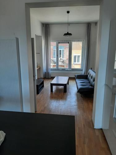 a living room with a couch and a table at apartment Amsterdamstr 1st fl in Ostend