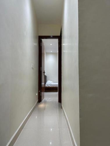 a hallway with a room with a bed and a door at Hotel PR in Amritsar