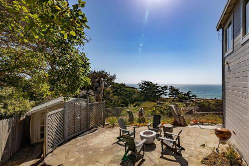 a patio with chairs and a view of the ocean at Oceanfront Coastal Home with Breathtaking Views Hiking Beaches & More in Moss Beach