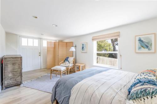 a bedroom with a large bed and a window at Oceanfront Coastal Home with Breathtaking Views Hiking Beaches & More in Moss Beach