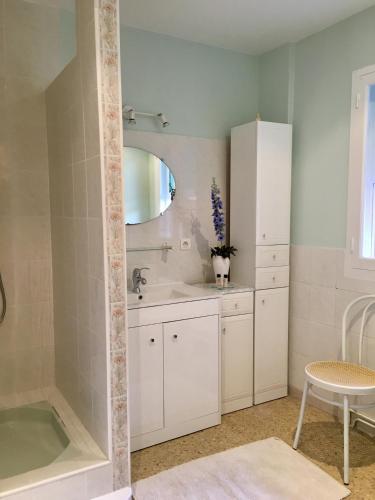 une salle de bain avec une baignoire, un lavabo et un miroir dans l'établissement La Pujauline, à Pujaut