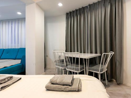 a bedroom with a bed and a table and chairs at Casa di VaLL in Ohrid