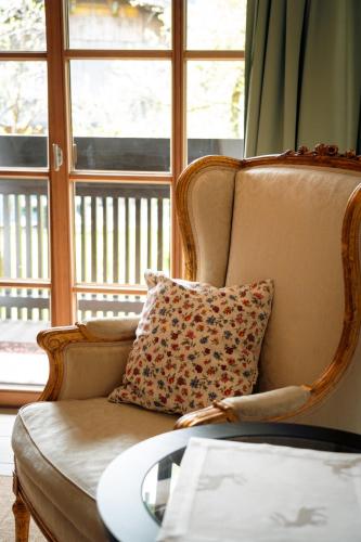 a couch with a pillow in front of a window at Landhaus Schösser-Brandler in Mayrhofen