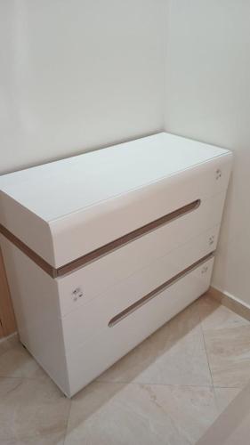 a white dresser with two drawers on top of it at superbe appartement en résidence balnéaire in Bouznika